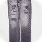 Grey distressed and repaired denim