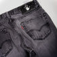 Grey distressed and repaired denim