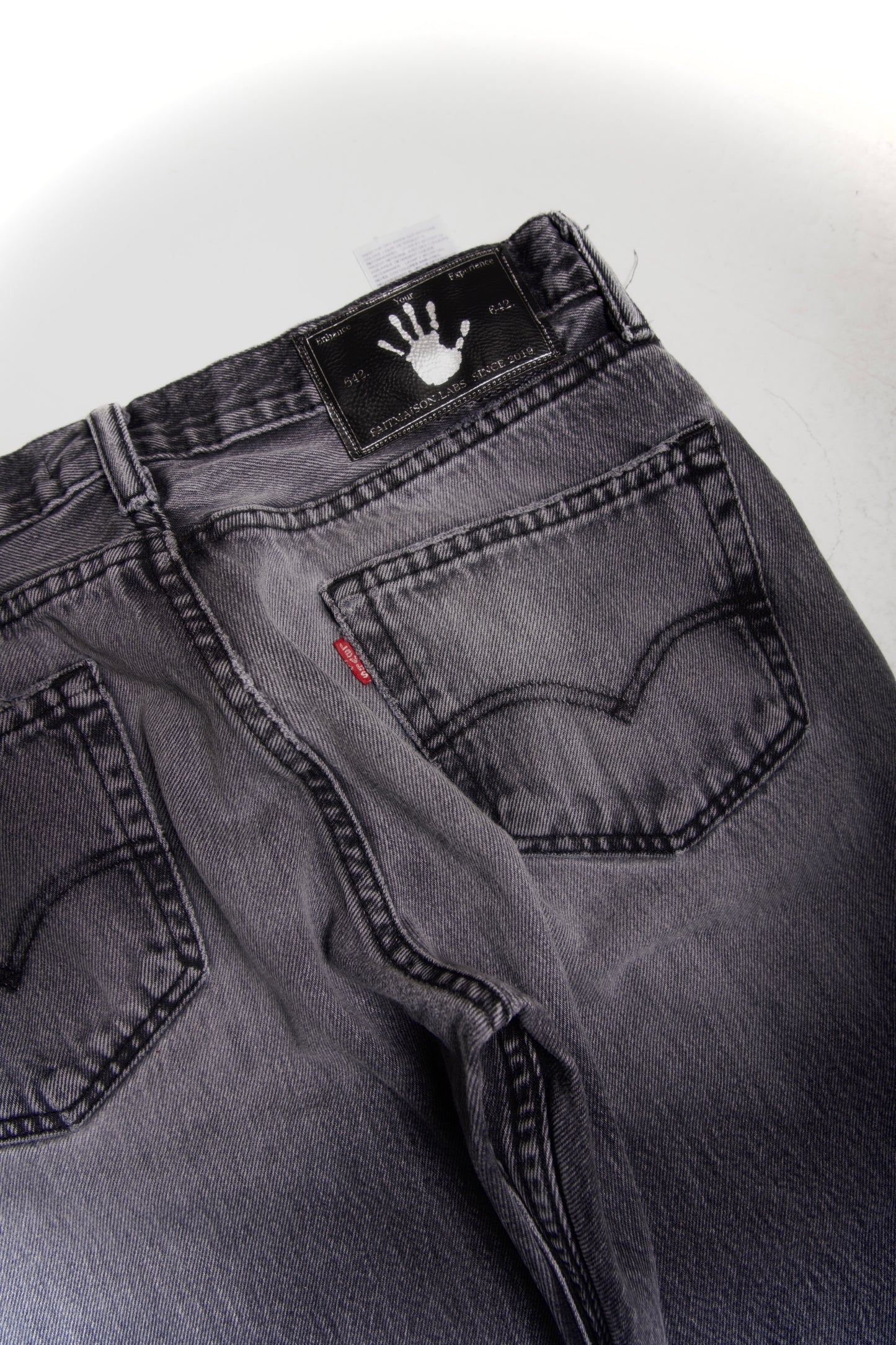 Grey distressed and repaired denim