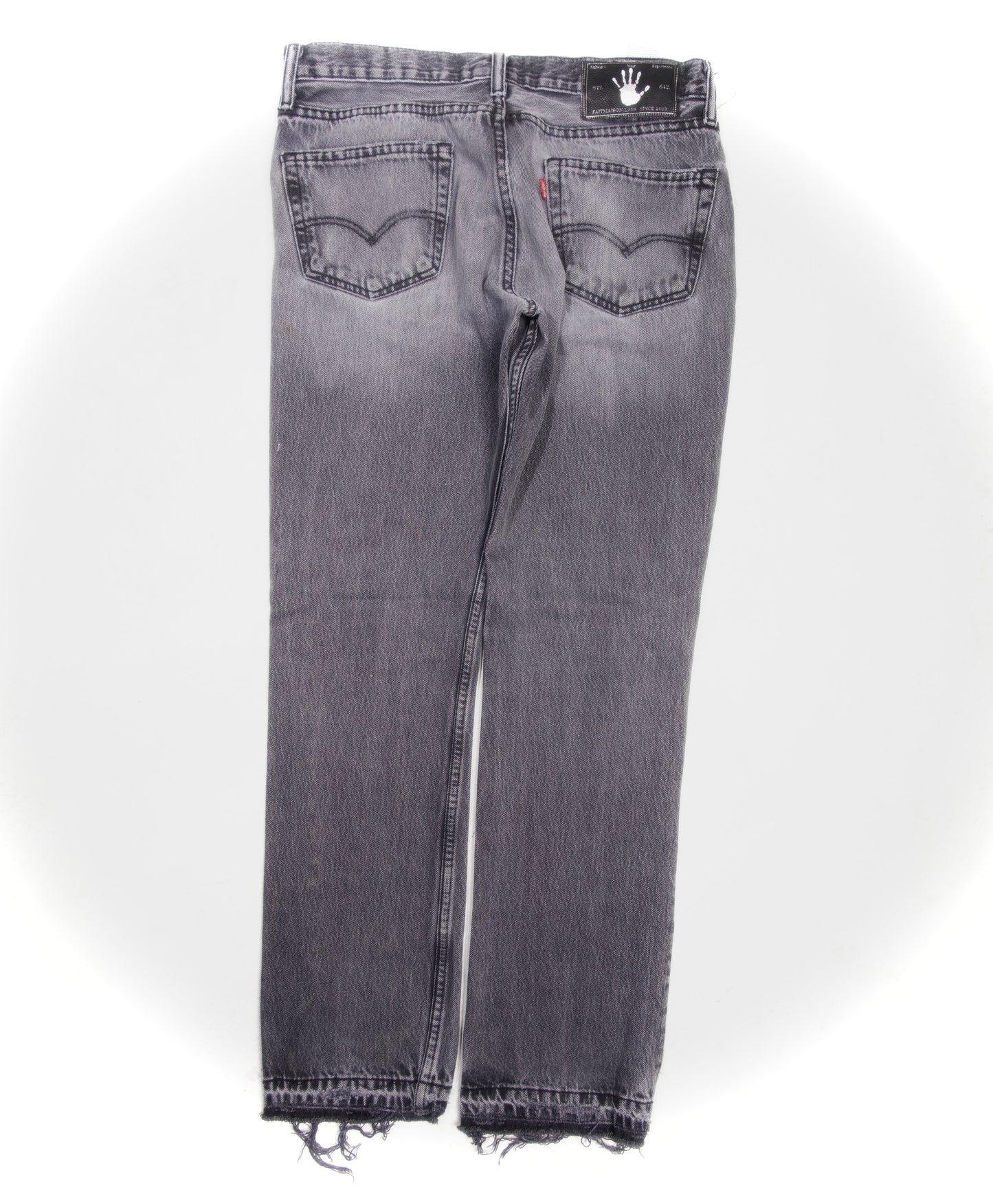 Grey distressed and repaired denim
